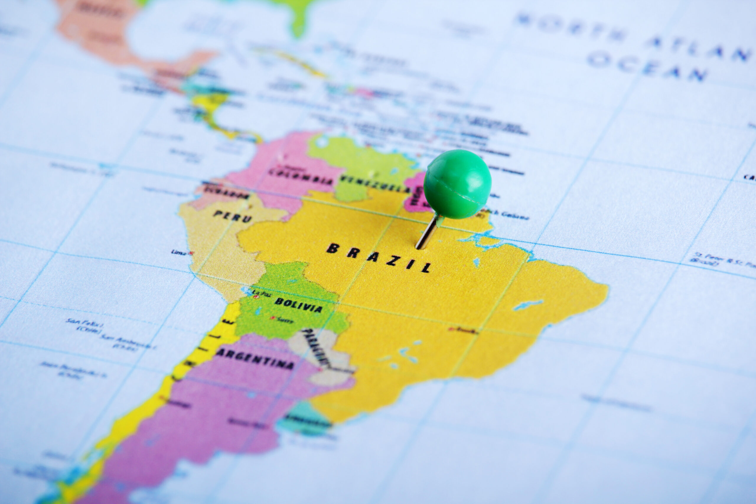 A map of south america with a green pin on it.